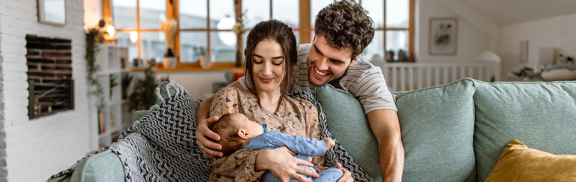 Happy young parents cuddling with their cute baby boy